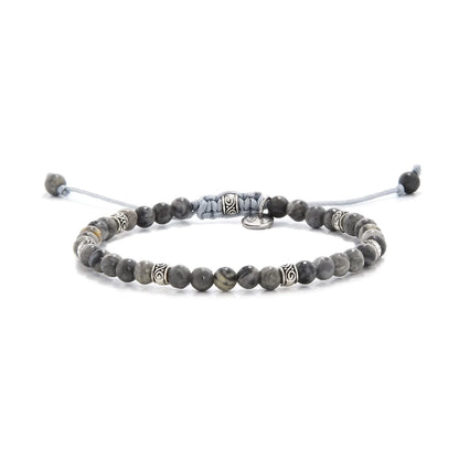 Beaded gray jasper bracelet with metal accent beads on adjustable cord.