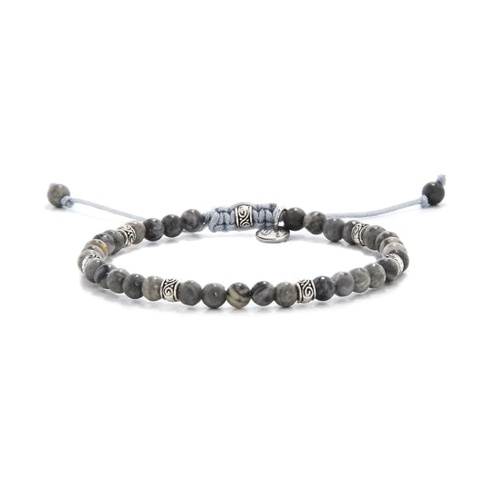Beaded gray jasper bracelet with metal accent beads on adjustable cord.