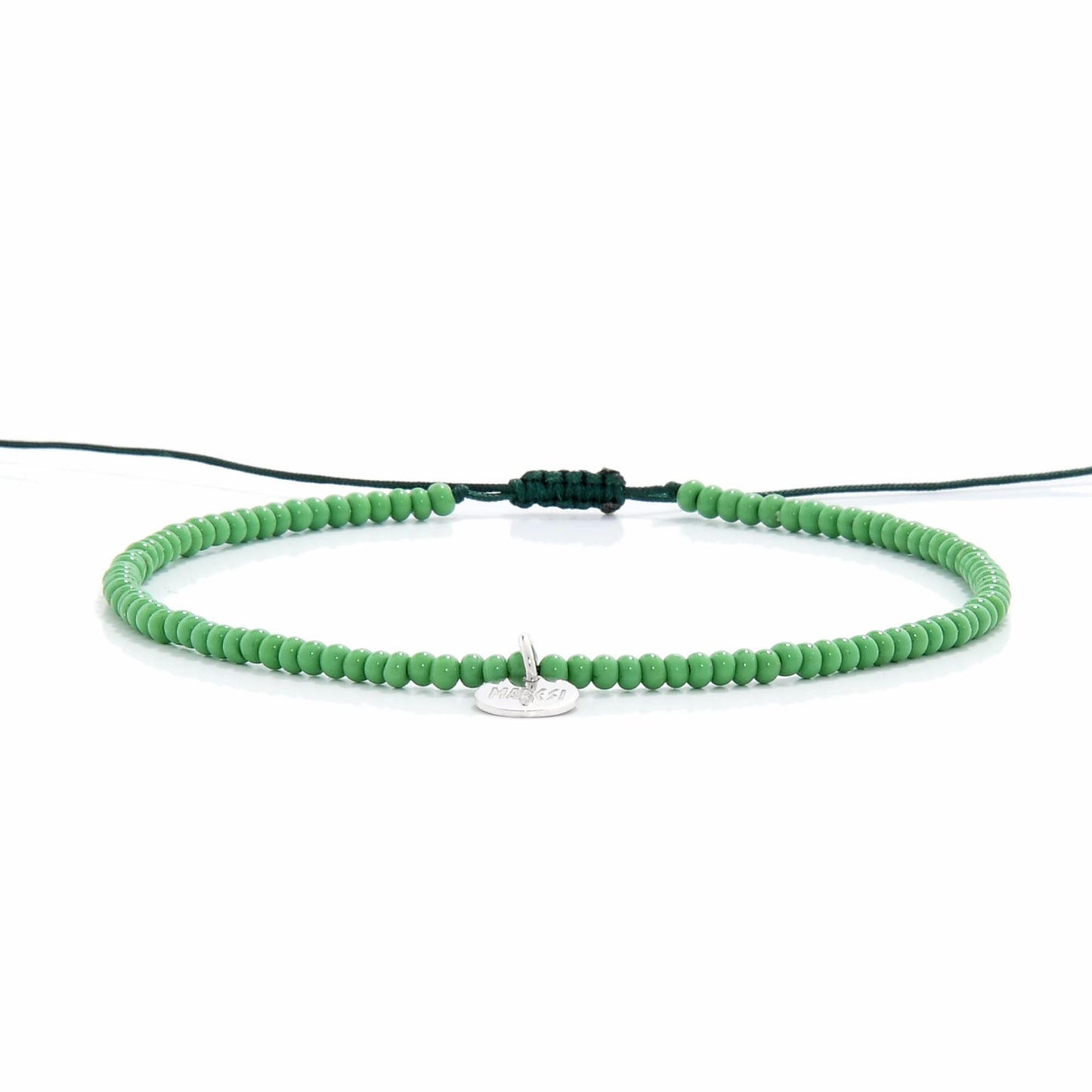 Minimalist green beaded stretch bracelet shown from side view

