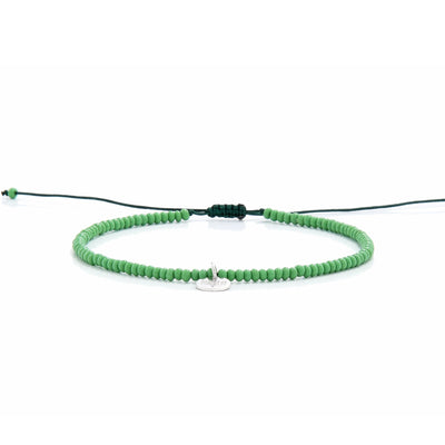 Minimalist green beaded stretch bracelet shown from side view
