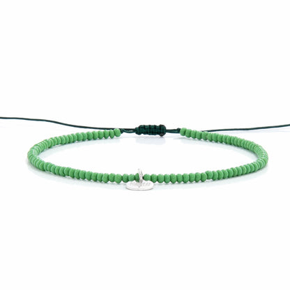 Minimalist green beaded stretch bracelet shown from side view

