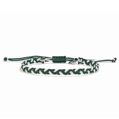 Handmade adjustable friendship bracelet in green and white with macrame-style knot and charm