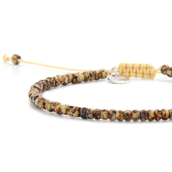 Side view of handmade men's bead bracelet with glazed brown beads and macrame closure