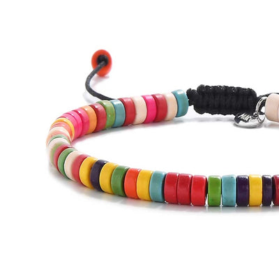 Handmade bracelet with round colorful beads on cord.