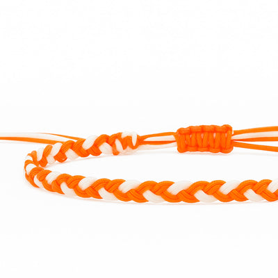 Handmade friendship bracelet using orange and white thread with sliding knot and charm