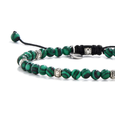 Malachite jewelry beads close-up showing bold green and black striping

