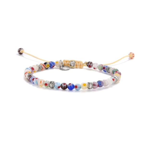 Handmade millefiori bracelet featuring colorful glass beads and metal spacers.