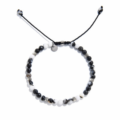 Top view of handmade zebra jasper bracelet with natural gemstone beads and silver accents.