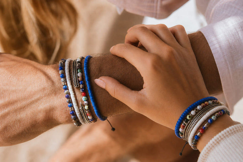 His and hers couple bracelets with stacked beads, silver accents, and matching blue details for partners.