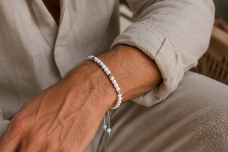 Jade Bracelet Beads styled on a man’s wrist with small white beads, silver spacers, and a beige linen shirt