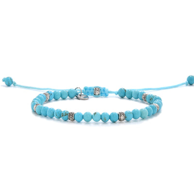 Handmade light blue turquoise bracelet with silver accents and adjustable cord.