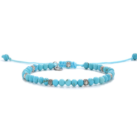 Handmade light blue turquoise bracelet with silver accents and adjustable cord.