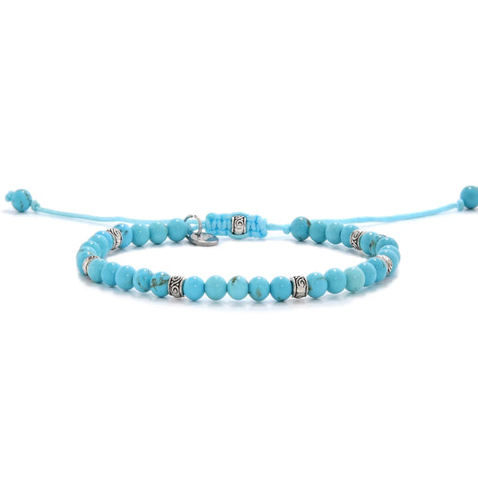 Handmade light blue turquoise bracelet with silver accents and adjustable cord.