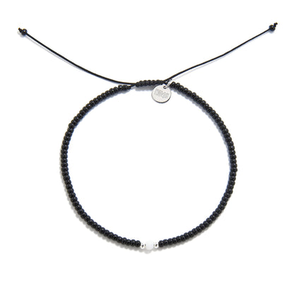 Overhead view of Loreto Blanco Diamanti bead bracelet black in circular form with white accent bead
