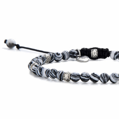 Malachite bracelet featuring smooth round beads with natural swirls and accents