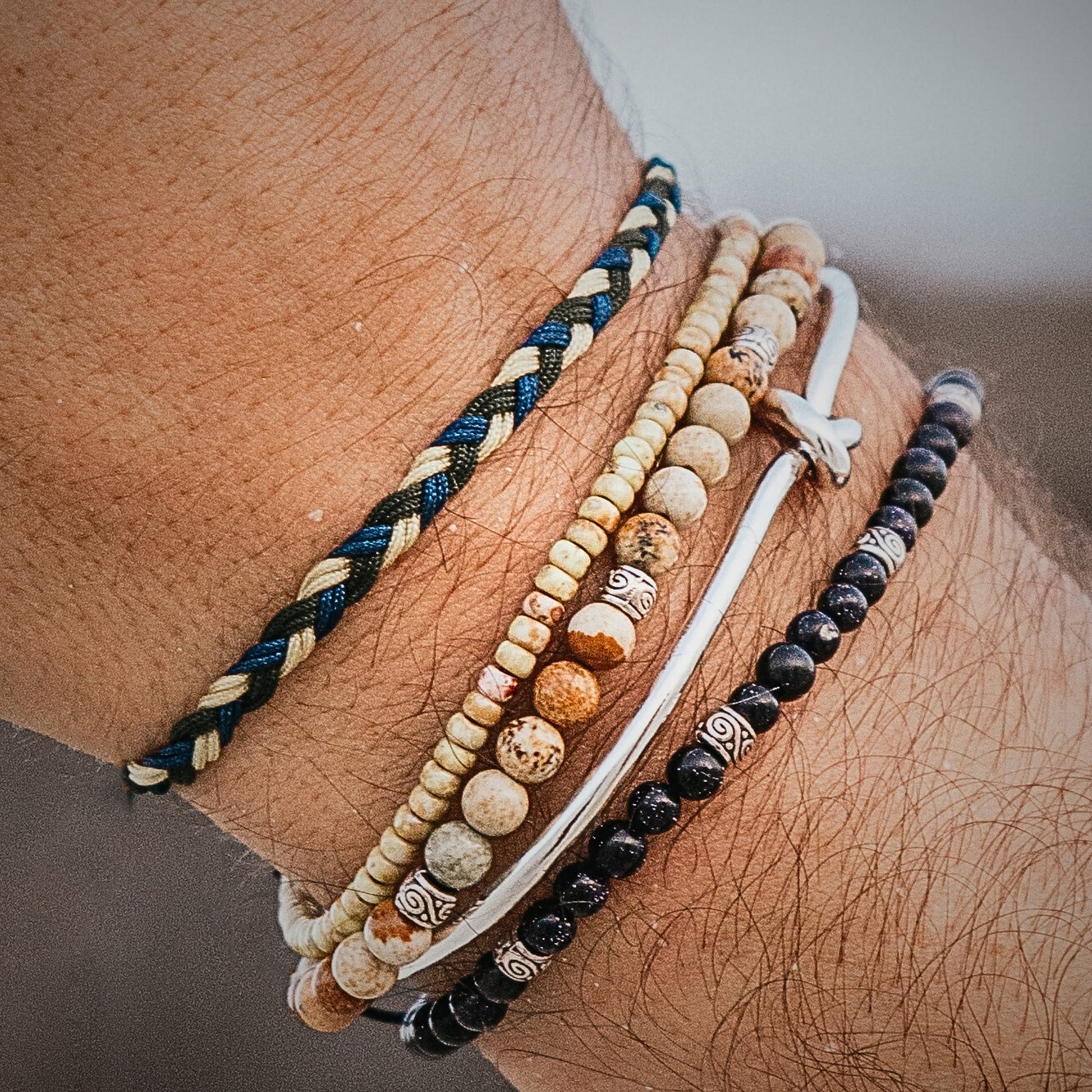 Handmade matching friendship bracelets with blue, beige, and green braided cord.