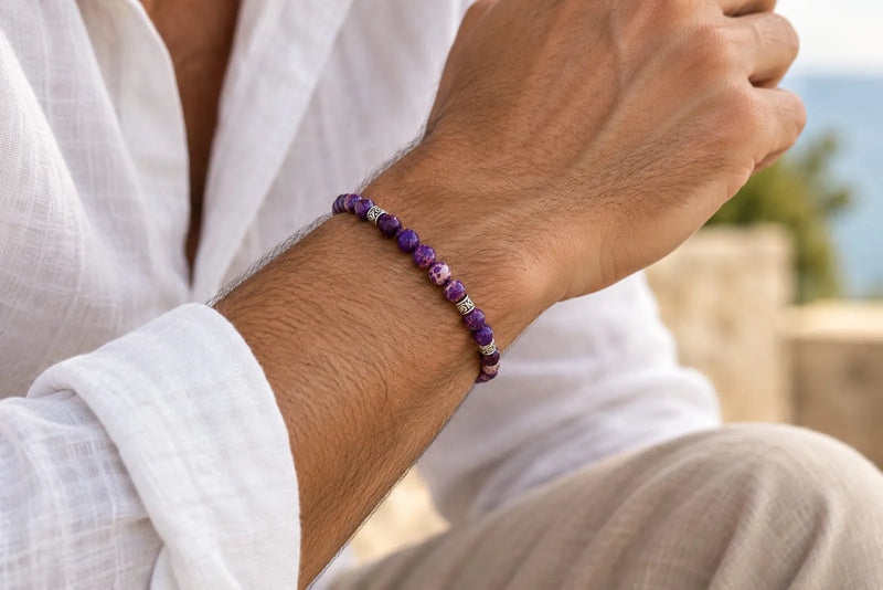 Man wearing a purple gemstone bracelet with a white linen shirt