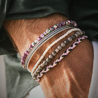 Mens friendship bracelets in pink, white, and green braided cord style.