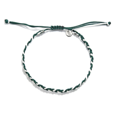 Flat lay of green and white adjustable friendship bracelet with charm and sliding knot