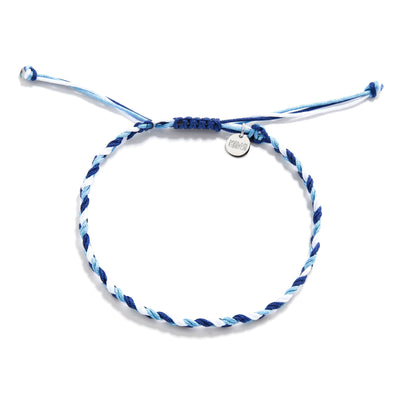 Flat lay of matching friendship bracelets in white, light blue, and navy with charm and knot