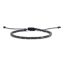 Minimalist seed bead bracelet featuring speckled black beads and sliding knot closure