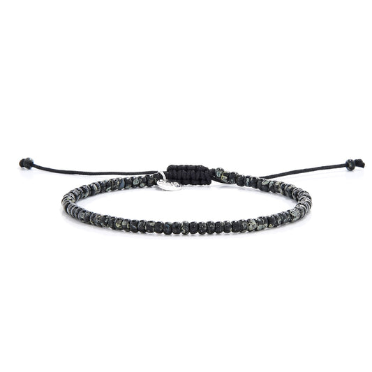 Minimalist seed bead bracelet featuring speckled black beads and sliding knot closure