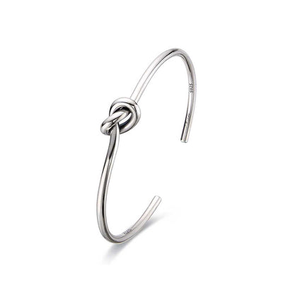 Polished mens cuff bracelets with knot centerpiece.