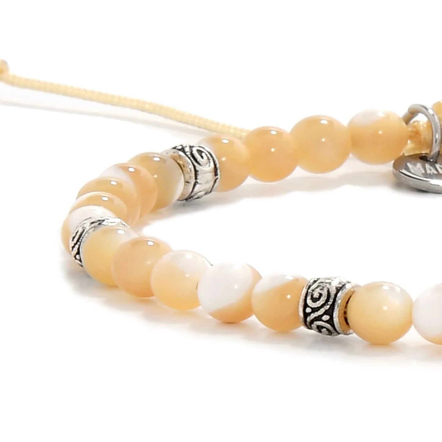 Detailed view of Mother of Pearl bracelet with silver spacer beads.