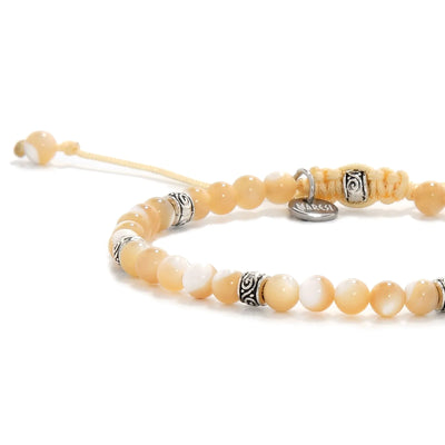 Close-up of Mother of Pearl bracelet showing smooth, glossy beads.