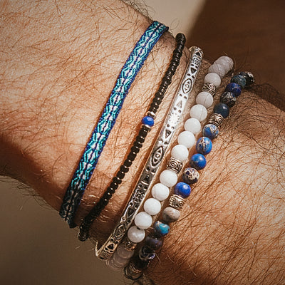 Wrist adorned with Mykonos bracelet set featuring mixed textures and silver stacking elements