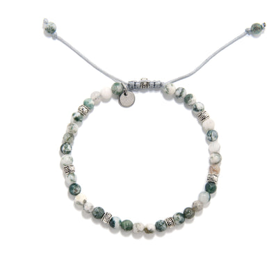 Top-down image of a round moss agate bracelet with a pull-string closure, displaying natural stone beads and decorative metal elements.