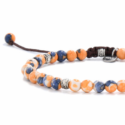 Close-up of Orange Flower Jasper bracelet showing detailed blue, white, and orange beads with silver spacers and a dark brown cord
