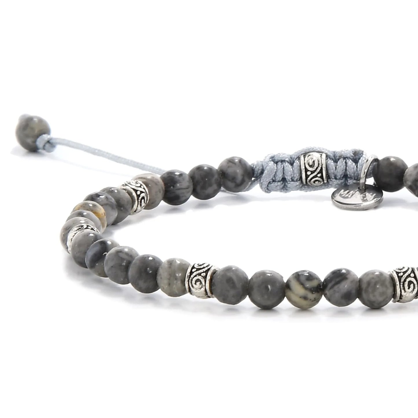 Close-up of polished gray stone beads with silver accent spacers.