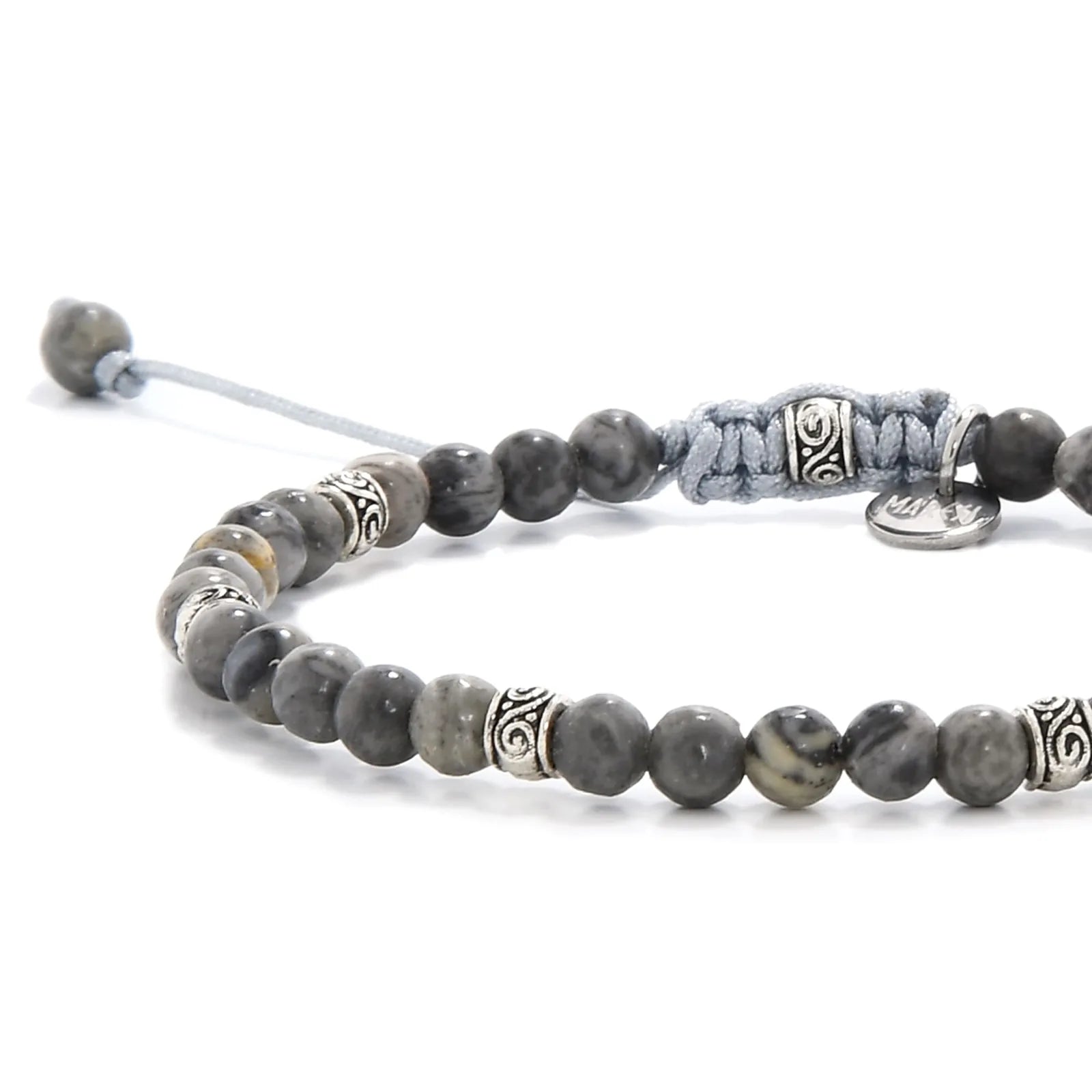 Close-up of polished gray stone beads with silver accent spacers.