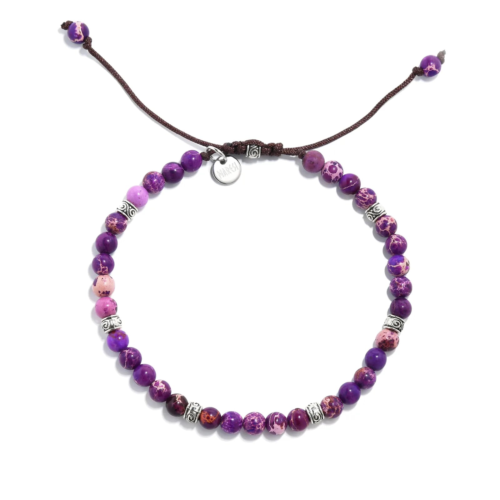 Overhead view of a purple jasper stone bracelet with silver accents on brown cord.