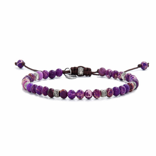Full view of purple jasper bracelet laid flat with silver beads and dark cord ends.