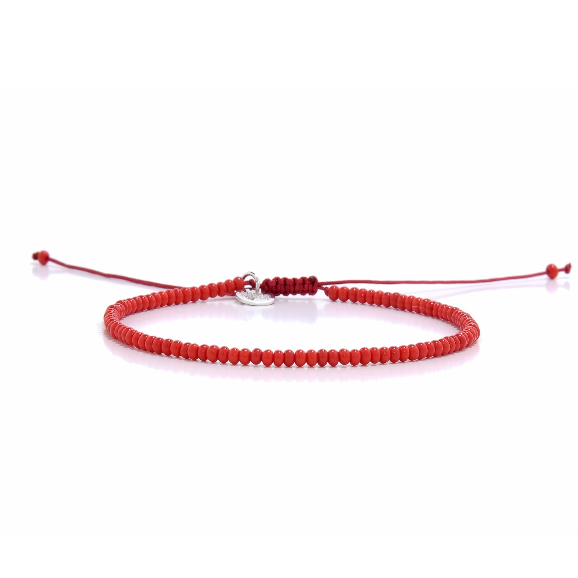 A men beaded bracelet with small red beads and an adjustable cord, shot from a straight-on perspective on a white background.