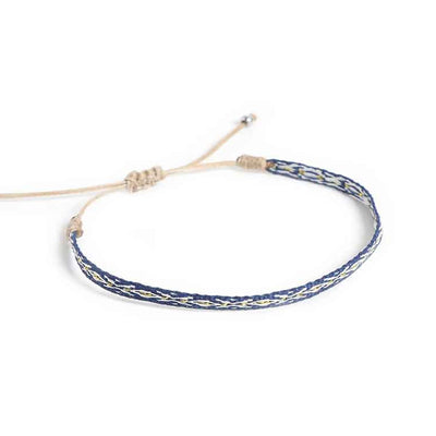 Top view of a rope bracelet for men in navy, white, and gold woven threads