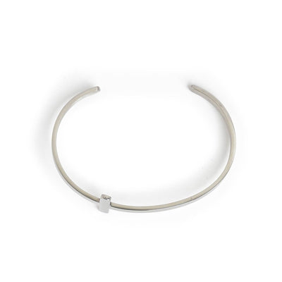 Open cuff cross bracelet with minimalist silver finish.