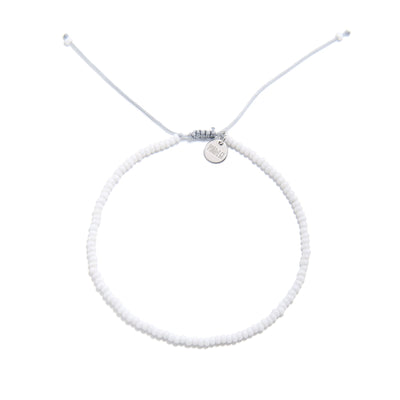 Small beaded bracelets handmade in white with adjustable cord and charm