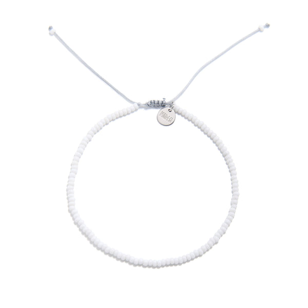 Small beaded bracelets handmade in white with adjustable cord and charm