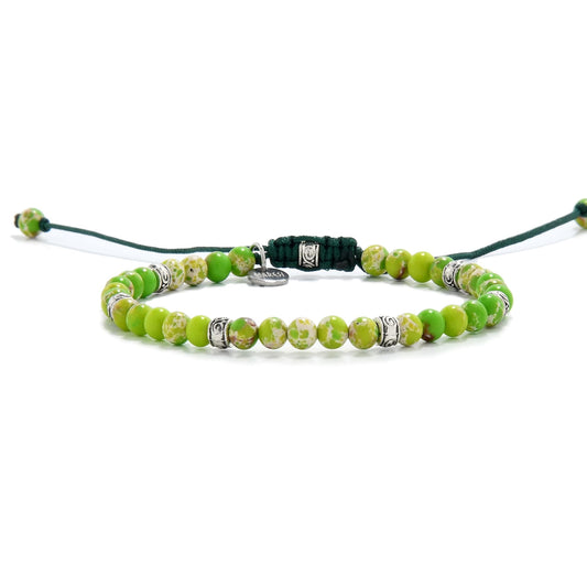 Side angle of green sea sediment jasper bracelet with mixed tone beads and adjustable dark green string