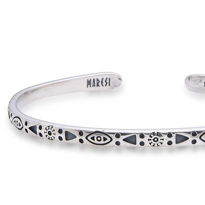 Detailed view of sterling silver men's bracelet with Maresi branding and tribal motif