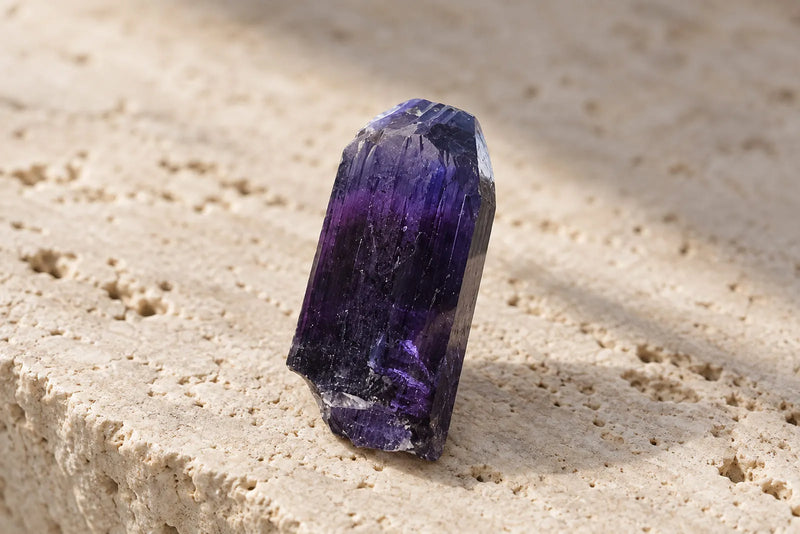 Natural tanzanite purple gemstone crystal with deep violet and blue tones