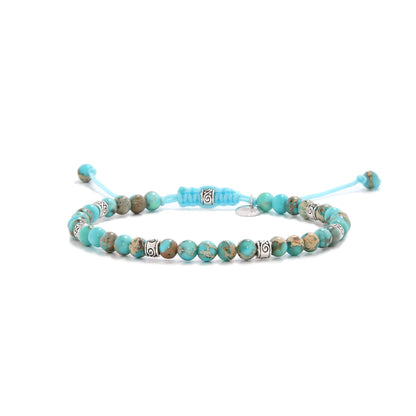 Turquoise jewelry bracelet with round beads and silver accent spacers.