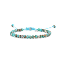 Turquoise jewelry bracelet with round beads and silver accent spacers.