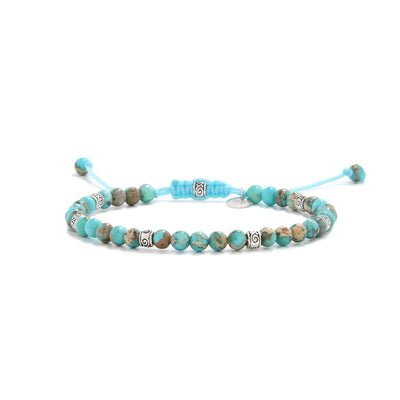 Turquoise jewelry bracelet with round beads and silver accent spacers.