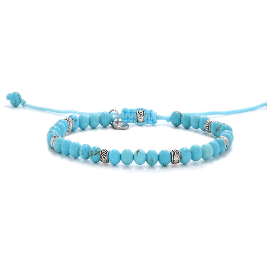 Turquoise bracelet with round beads and silver spacers, adjustable cord design