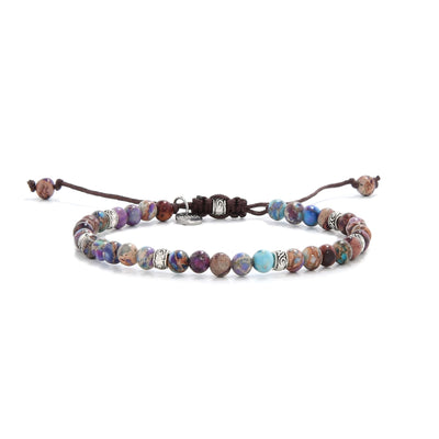 Violet sea sediment bracelet with round beads and silver accents on brown cord