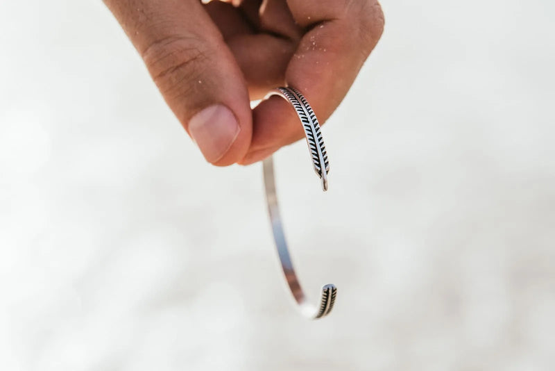 What Is a Bangle Bracelet? Silver bangle held in hand